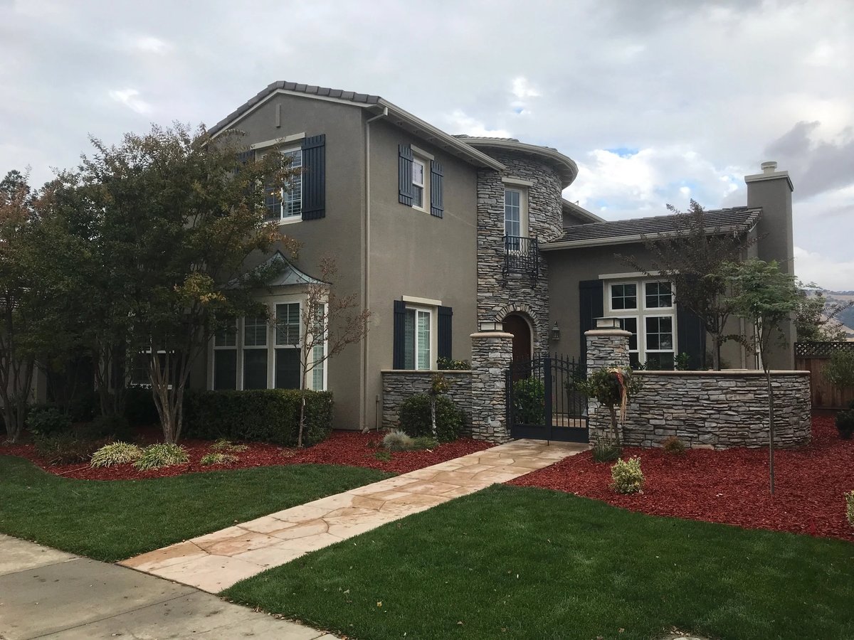 Home with stone veneer and freshly painted stucco